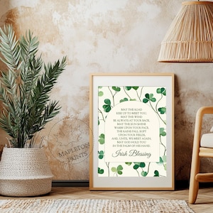 May include: A printable wall art design featuring an Irish blessing with a green shamrock background. The text reads: "May the road rise up to meet you. May the wind be always at your back. May the sun shine warm upon your face, the rains fall soft upon your fields. And, until we meet again, may God hold you in the palm of his hand. Irish Blessing"