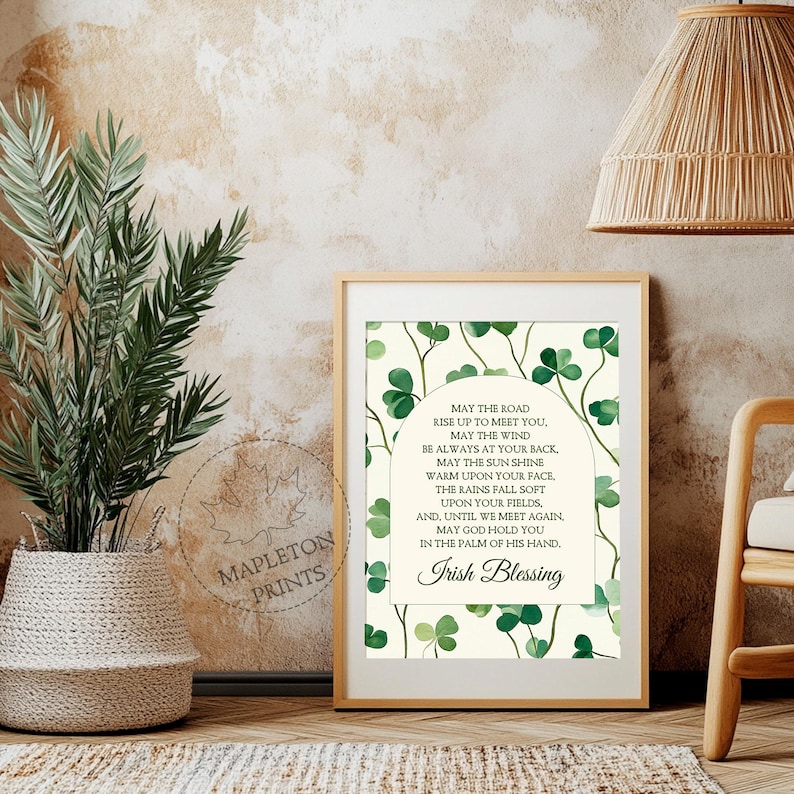 May include: A printable wall art design featuring an Irish blessing with a green shamrock background. The text reads: "May the road rise up to meet you. May the wind be always at your back. May the sun shine warm upon your face, the rains fall soft upon your fields. And, until we meet again, may God hold you in the palm of his hand. Irish Blessing"
