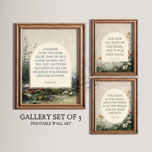 May include: Gallery set of three framed prints with botanical illustrations and Bible verses. The prints feature floral arrangements and text from Luke 12:27, Genesis 1:31, and Psalm 24:1. The frames are a warm brown color.
