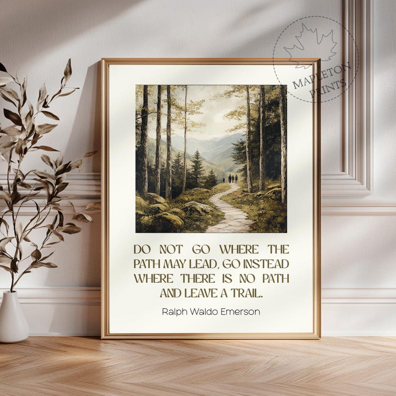 May include: A framed print with a quote by Ralph Waldo Emerson: "Do not go where the path may lead, go instead where there is no path and leave a trail." The print features a painting of a forest path leading through a lush green forest.