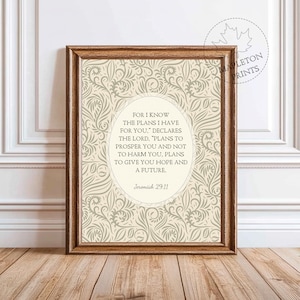 May include: A framed print with a light brown wooden frame. The print features a beige background with a floral pattern. The text in the center reads "For I know the plans I have for you...Jeremiah 29:11."