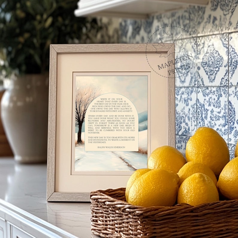 May include: A framed print with a watercolor painting of a snowy landscape and a quote by Ralph Waldo Emerson. The quote reads: "Write it on your heart that every day is the best day in the year. He is rich who owns the day, and no one owns the day who allows it to be invaded with fret and anxiety."