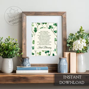 May include: Printable art print with a white background and green shamrock pattern. The print features a traditional Irish blessing with the text "May the road rise up to meet you. May the wind be always at your back. May the sun shine warm upon your face. The rains fall soft upon your fields. And, until we meet again, may God hold you in the palm of his hand. Irish Blessing."