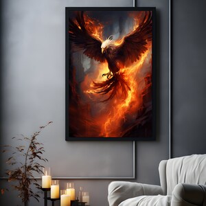 May include: A framed artwork depicts a phoenix in flight, rendered in fiery hues of orange, red, and brown. The mythical bird has outstretched wings and a white head, set against a dark, smoky background. The artwork is displayed on a gray wall.