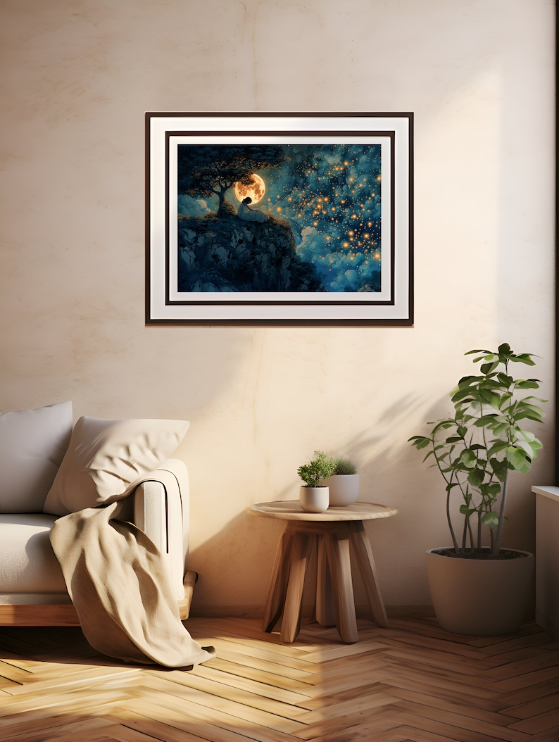 May include: A framed print of a painting depicting a person sitting on a cliff under a full moon with a starry sky in the background.
