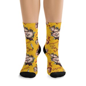 May include: Yellow socks featuring a repeating pattern of a scary doll face, blood splatters, and the text "FRIENDS TILL THE END". The socks have black heels and toes.