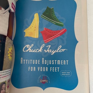 May include: A vintage-style advertisement for Chuck Taylor sneakers featuring three pairs of high-top sneakers in yellow, red, and green. The ad text reads "Attitude Adjustment for Your Feet" and "Choose Your Chuck Wisely". The ad also states that the sneakers are available exclusively at Journeys.