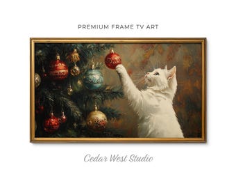 May include: A rectangular framed digital artwork titled PREMIUM FRAME TV ART by Cedar West Studio. The image depicts a white cat reaching up to touch a red Christmas ornament hanging on a dark green pine tree decorated with various baubles.