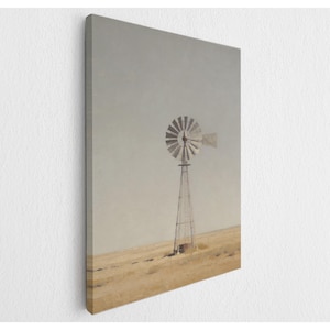 May include: A canvas print featuring a sepia-toned landscape with a windmill. The windmill, with its metal blades and tall tower, stands against a muted sky and a field of dry grass. The artwork evokes a sense of rural Americana and rustic charm.