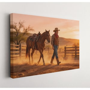 May include: A canvas print depicts a cowboy walking alongside a saddled brown horse in a dusty, sunlit landscape. The cowboy wears a hat, vest, and jeans. A wooden fence and trees are in the background, with a warm, orange sky.
