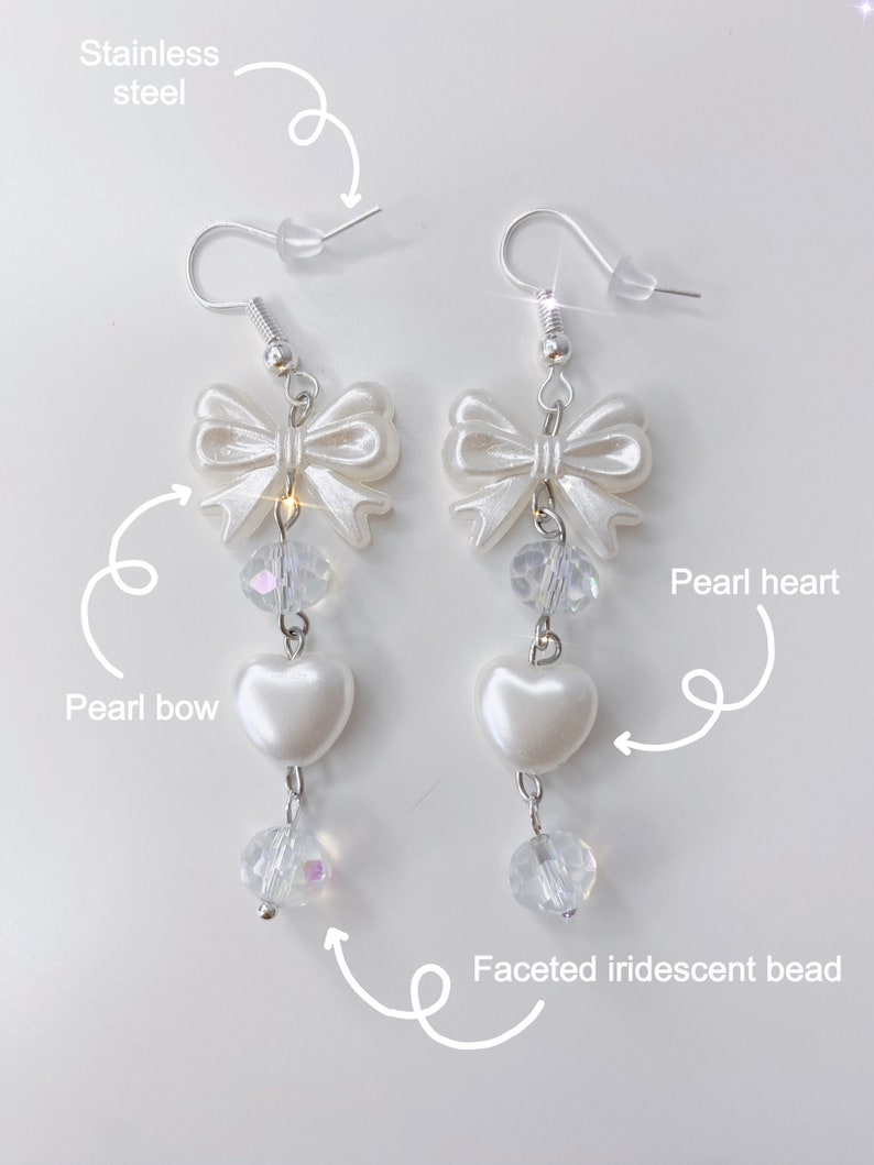 White earrings with a pearl bow, iridescent earrings and pearl hearts with a description about the materials.