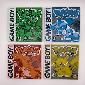 May include: Four different versions of the classic Game Boy Pokemon game cartridges. The cartridges are green, blue, red, and yellow. Each cartridge features a different Pokemon character on the front. The text on the cartridges reads "Gotta catch 'em all!" and "Game Boy".