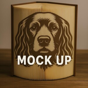 May include: A decorative book with a brown cover and pages, featuring a detailed brown dog portrait on the front. The text "MOCK UP" is displayed in white across the image. The book is open, revealing the textured pages.