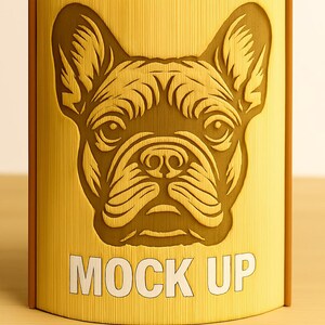 May include: A yellow box with a detailed embossed image of a French Bulldog's face. The box has a vertical ribbed texture and the words "MOCK UP" in white block letters.