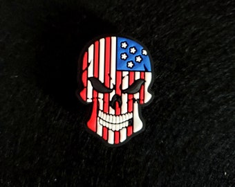 May include: A black skull with a red, white, and blue American flag design.