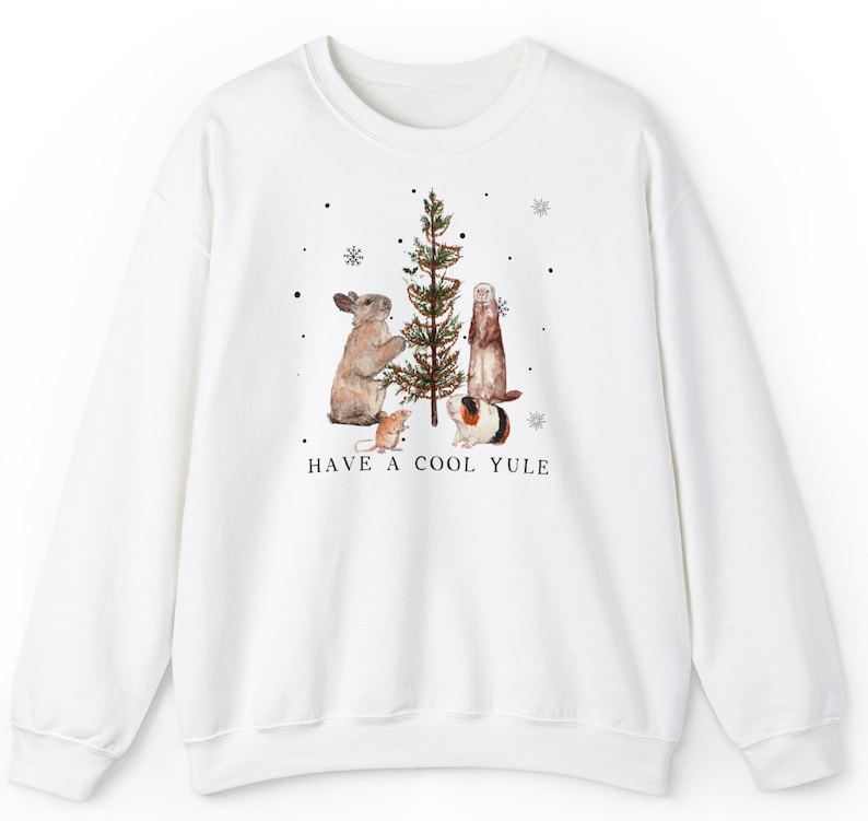 May include: White sweatshirt with a Christmas tree design featuring a rabbit, ferret, and guinea pig decorating the tree. The text "HAVE A COOL YULE" is printed below the image.