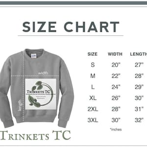 May include: Size chart for a gray sweatshirt with the text "TRINKETS TC" and a logo of a plant with the text "Handmade Native and Science Themed Jewelry" printed on the front. The chart shows sizes from S to 3XL with corresponding width and length measurements in inches.