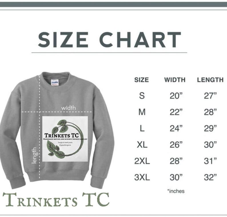 May include: Size chart for a gray sweatshirt with the text "TRINKETS TC" and a logo of a plant with the text "Handmade Native and Science Themed Jewelry" printed on the front. The chart shows sizes from S to 3XL with corresponding width and length measurements in inches.