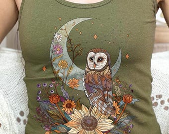 May include: A green tank top featuring a graphic of an owl perched on a crescent moon surrounded by flowers and stars. The text "Military green" is visible in the top right corner of the image.
