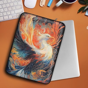 May include: A laptop sleeve with a colorful phoenix design. The phoenix is depicted in a vibrant mix of orange, yellow, blue, and purple hues, with intricate details and a dynamic pose. The sleeve is made of a durable material and features a zipper closure.