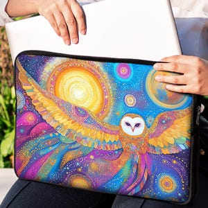 May include: A colorful laptop sleeve with a galaxy and owl design. The owl is flying with its wings spread wide. The sleeve is made of a soft, durable material and is perfect for protecting your laptop.
