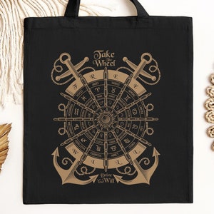 May include: Black tote bag featuring a gold design of a ship's wheel with nautical symbols and the text "Take the Wheel Drive with Will".