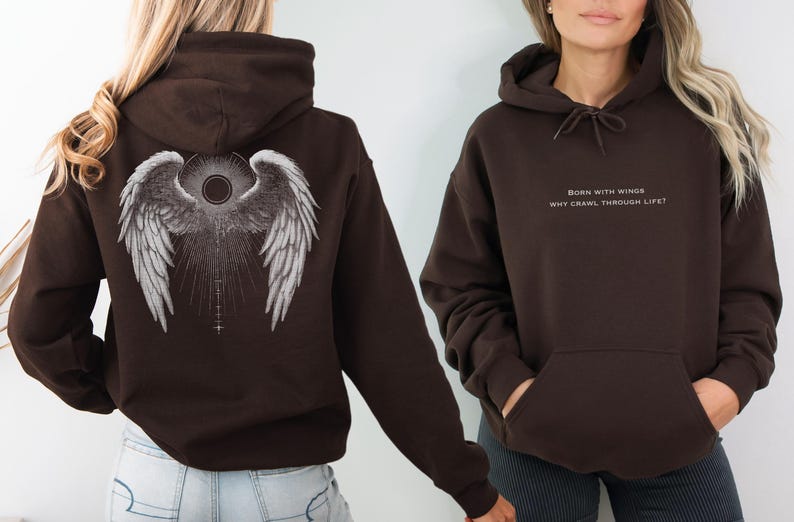 May include: Two brown hoodies. One features angel wings on the back, the other has the text "BORN WITH WINGS WHY CRAWL THROUGH LIFE?" in white. Both have a drawstring hood and a front pocket.
