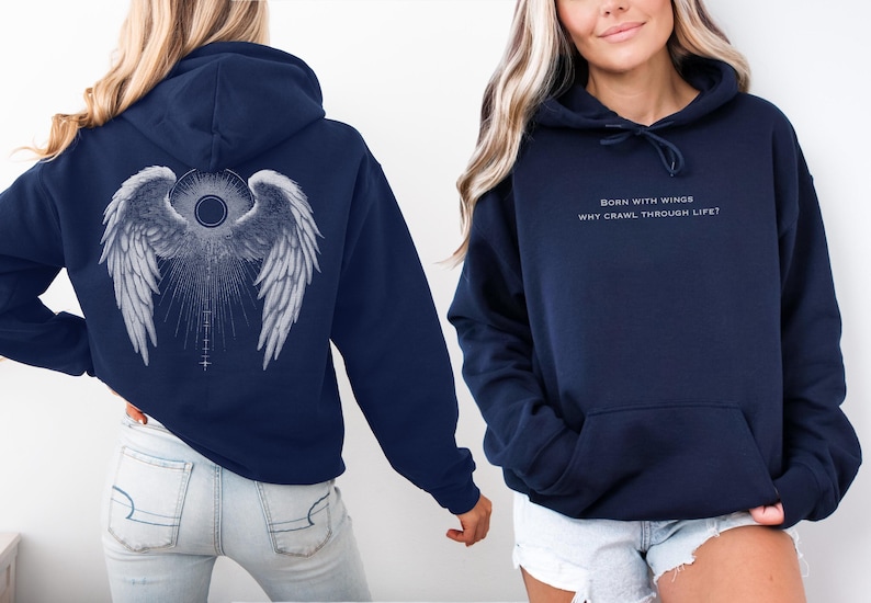 May include: Navy blue hoodie with a large white angel wing design on the back. The front of the hoodie has the text "BORN WITH WINGS WHY CRAWL THROUGH LIFE?" in a light color. The hoodie has a front pocket and a drawstring hood.