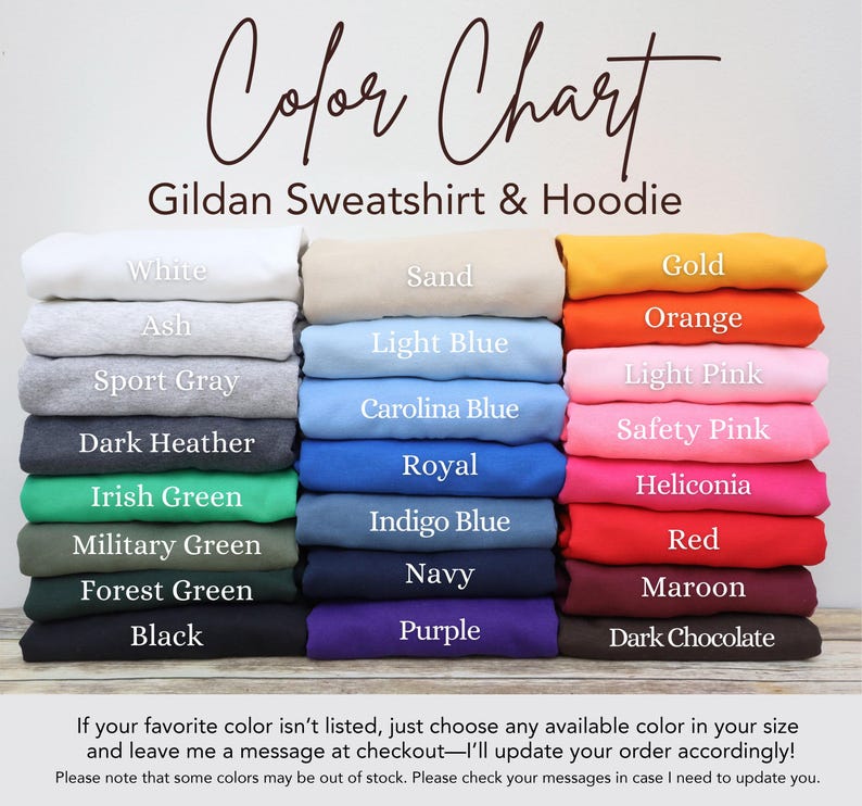 May include: A color chart for Gildan sweatshirts and hoodies displaying twenty-four folded fabric options labeled with names including White, Sand, Gold, Ash, Light Blue, Orange, Sport Gray, Carolina Blue, Light Pink, Dark Heather, Royal, Safety Pink, Irish Green, Indigo Blue, Heliconia, Military Green, Navy, Red, Forest Green, Purple, Black, Maroon, and Dark Chocolate.