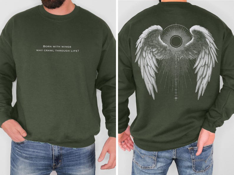May include: Olive green sweatshirt with white text on the front that reads "BORN WITH WINGS WHY CRAWL THROUGH LIFE?". The back features a detailed white graphic of angel wings with a sunburst design. A crew neck sweatshirt.