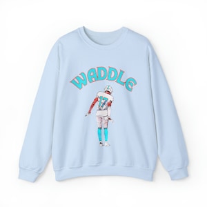 May include: Light blue sweatshirt with a graphic of a football player wearing a teal and orange jersey with the number 17. The text "WADDLE" is printed in teal above the player.