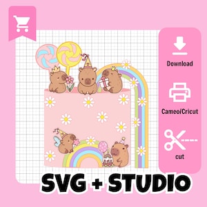 May include: A pink birthday cake design with cartoon capybaras, lollipops, and a rainbow. The cake is decorated with daisies and the text "SVG + STUDIO". Includes icons for download, printing, and cutting.