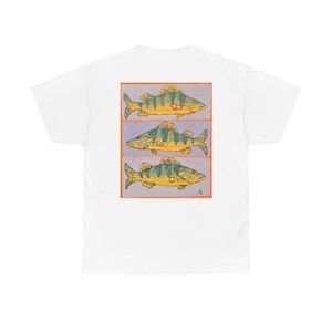May include: A white t-shirt featuring a rectangular graphic on the back. The graphic contains three stacked illustrations of yellow and green fish, each separated by thin lines, all enclosed within a bold orange border on a light purple background.