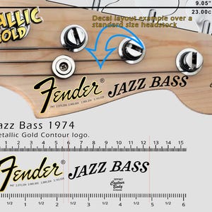May include: A close-up of a Fender Jazz Bass headstock decal layout example. The image shows the headstock with tuning pegs, the Fender logo, and the text "JAZZ BASS". The decal layout is 9.05 inches (23.00 cm) wide.