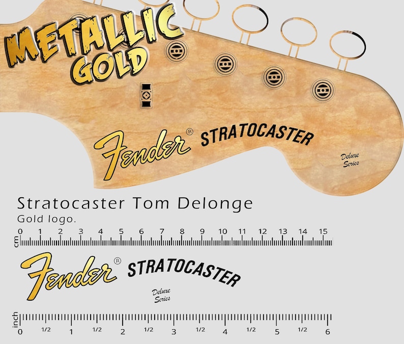 May include: A close-up of a guitar headstock with the words "METALLIC GOLD" in gold lettering. The Fender logo and "STRATOCASTER" are also visible. A ruler shows measurements in inches.