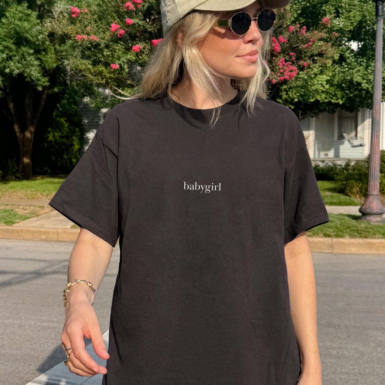 Pop Culture Tshirt Babygirl Slogan Cotton Top Trendy Fashion Piece Movie Reference Inspired Design Romantic Gift Idea Girlfriend Valentine Present Relationship Humor Affectionate Message Soft Lightweight Material Casual Outfit Daily Wear