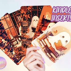 May include: Five illustrated cards featuring a ghost reading a book in a library setting. The cards are designed for use as Kindle inserts. The text "Kindle Inserts" is displayed in purple text at the top of the image.