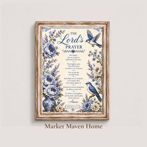 May include: Framed print featuring "The Lord's Prayer" with floral and bird illustrations. The text is surrounded by blue and white flowers and two blue birds. The frame is a light brown color.