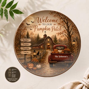 May include: A round ceramic plate featuring a fall-themed illustration of a red truck, a barn, and pumpkins. The text reads Welcome to Our Pumpkin Patch, The Johnson's, and four names on a signpost. A small circular icon indicates dishwasher and microwave safety.