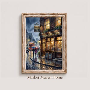 May include: A framed wall art print depicting a rainy London street scene at dusk. The image features a pub named The Golden Lion with warm interior lighting, a red double-decker bus, and pedestrians with umbrellas on a wet cobblestone street.