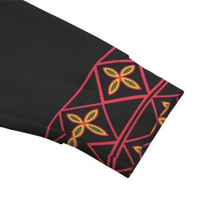 May include: Black fabric with a decorative border featuring a geometric pattern of red lines and yellow and red flower-like shapes. The design is on the edge of the fabric.