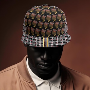 May include: A black and brown patterned baseball cap with a black and white chain pattern on the brim. The cap has a red and yellow stripe on the side.