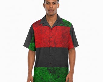 May include: A short-sleeved button-down shirt featuring a color-blocked design with a textured red upper panel, a solid dark gray middle section, and a textured green lower panel. The shirt has a classic collar and a front button closure.