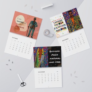 May include: A collection of three monthly calendars with illustrations and inspirational quotes. The October calendar features a man with a cane, the November calendar has a woman with colorful hair, and the December calendar showcases a man in a patterned suit.