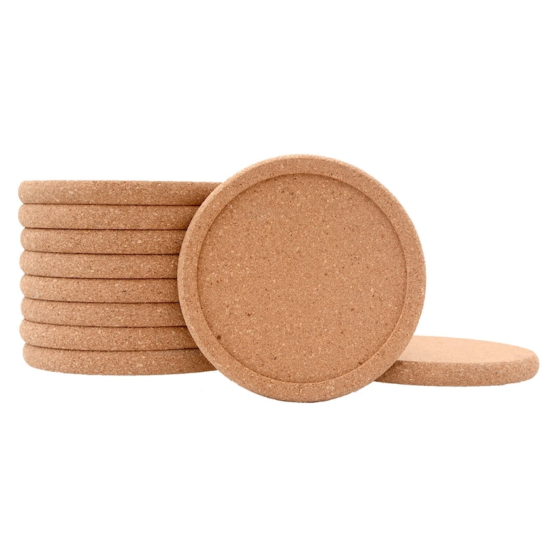 May include: A stack of round cork coasters. The coasters are a light brown colour and have a smooth, slightly textured surface.