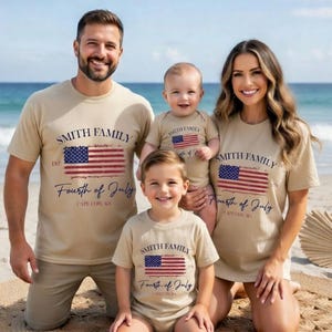 A family of four, consisting of a man, a woman, and two children, posing on a beach with a beige t-shirt that reads "Smith Family Fourth of July Cape Cod, MA".