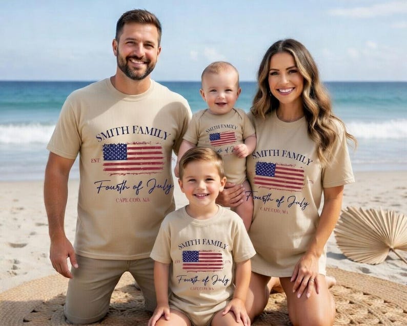 A family of four, consisting of a man, a woman, and two children, posing on a beach with a beige t-shirt that reads "Smith Family Fourth of July Cape Cod, MA".
