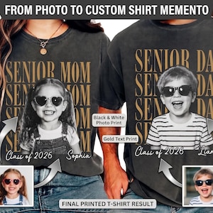 May include: Black t-shirts with gold text and black and white photo prints. One shirt says "Senior Mom" with a photo of a girl, the other says "Senior Dad" with a photo of a boy. Both shirts have "Class of 2026" and a name.