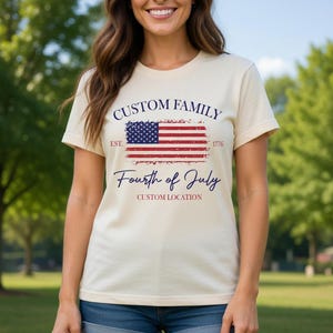 A woman wearing a white t-shirt with a graphic design featuring the American flag and the text "Custom Family" and "Fourth of July Custom Location" printed on it.