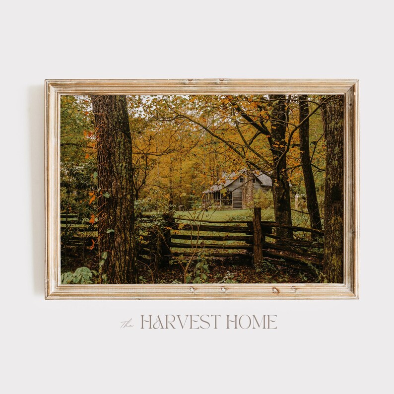 May include: A rustic wooden cabin nestled in a forest with vibrant autumn foliage. A wooden fence runs in front of the cabin, with trees and leaves in the foreground. The text "the HARVEST HOME" is visible at the bottom of the image.